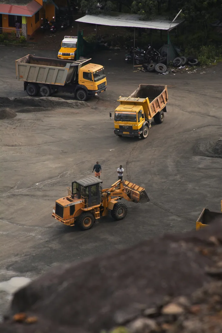 Haul trucks and heavy equipment at a materials site