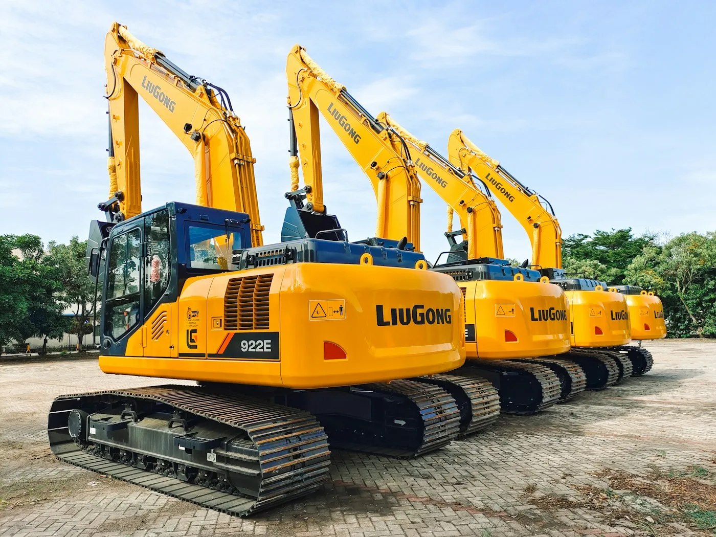 Tracked excavators parked in an equipment yard